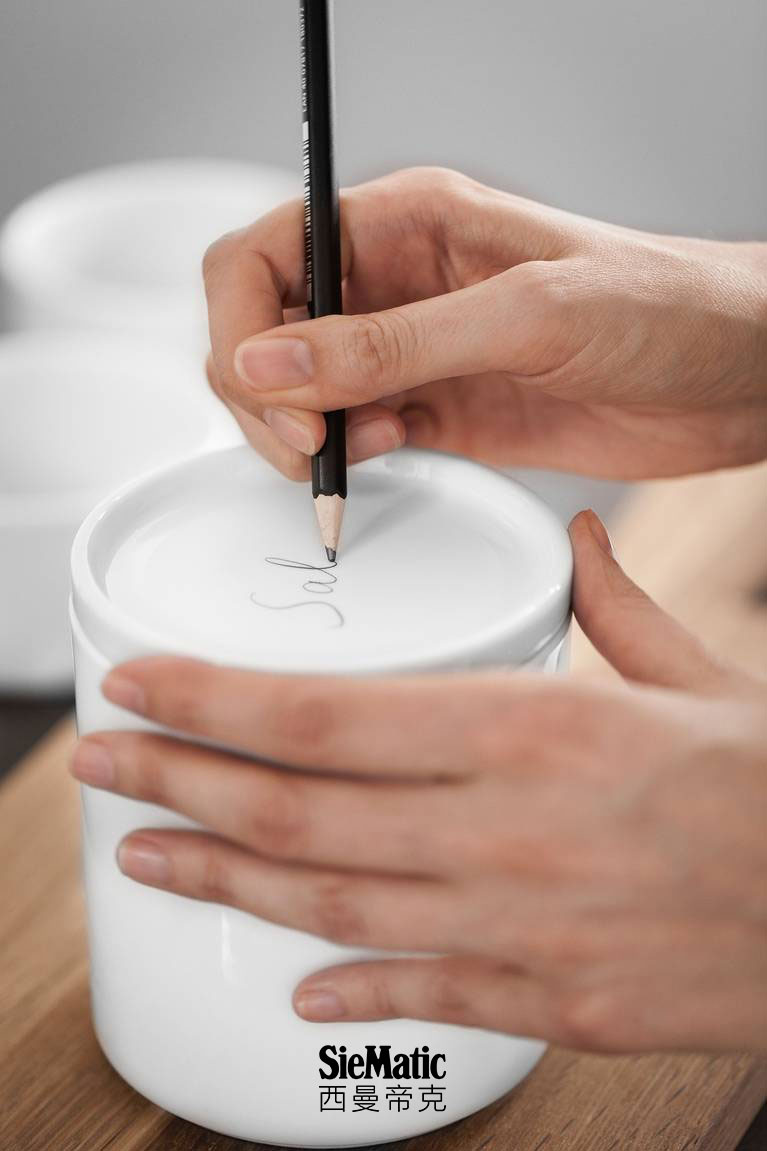 White SieMatic porcelain containers individually labeled in pencil